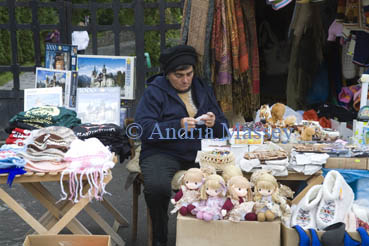Transylvania Romania EU SeptemberA Romanian woman stallholder crochetting whilst waiting for customers for her souvenirs