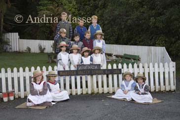 GREYMOUTH CENTRAL SOUTH ISLAND NEW ZEALAND May Group of schoolchildren dressed in 1860s costume posing in front of Marsden Valley School in Shantytown a replica gold mining town