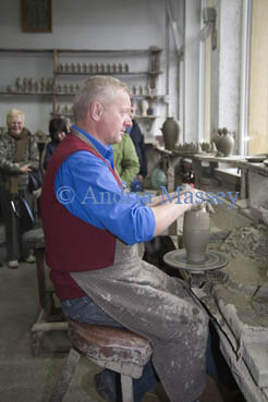 Marginea Romania EU September Group of tourists watching a potter shaping a vase made as a souvenir