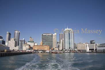 AUCKLAND NORTH ISLAND NEW ZEALAND May Looking back to Queens Wharf and the rich red and tan colours of the sandstone and brick of the beautiful waterfront 1912 Ferry Building from a ferry in Waitemata Harbour