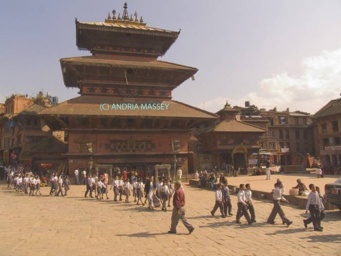 BHAKTAPUR NEPAL November School children walking past Bhairava Temple in Taumadhi Tole built in a typical rectangular plan of a Bhairava or Bhimsen shrine in the style of a house 