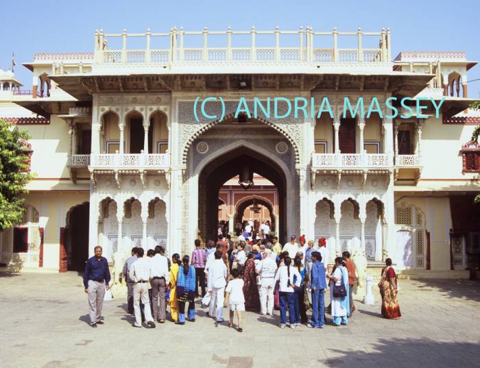 JAIPUR RAJASTHAN INDIA November Some of the many visitors passing through Rajendra Pol flanked by two elephants entering the inner courtyard of the City Palace