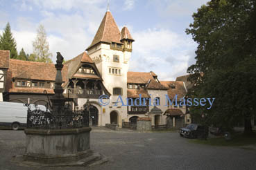 Sinaia Transylvania Romania EU September The courtyard with a stone monument in front of the entrance gate tower of Peles Castle