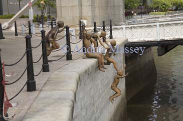 SINGAPORE ASIA May The First Generation a sculpture by Chong Fah Cheong of young naked boys jumping into the Singapore River on the riverbank at Boat Quay