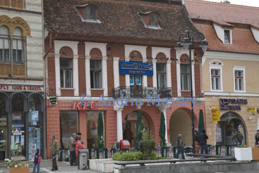 Brasov Transylvania Romania EU September Shops KFC fast food restaurant and bank buildings flanking the main square of this historic medieval city