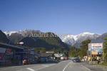 FRANZ JOSEF WEST COAST SOUTH ISLAND NEW ZEALAND May Looking up the main street of this small village with the snow covered Southern Alps towering in the background
