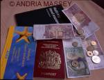 Passport, insurance policy and a selection of foreign currency