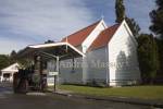 GREYMOUTH CENTRAL SOUTH ISLAND NEW ZEALAND May The preserved wooden church and a McLaren Traction engine in Shantytown a cultural and heritage experience