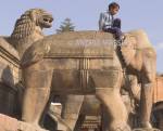 BHAKTAPUR NEPAL November Nepalese boy sitting on one of the elephants flanking the staircase of Nyatapola Mandir