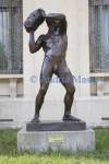 Bucharest Romania EU September Stone Thrower a bronze sculpture of a nude man by Frederic Storck 1872 - 1942  in the grounds of the George Enescu Museum