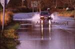 Car driving along flooded road Lavant West Sussex

Format: 35mm