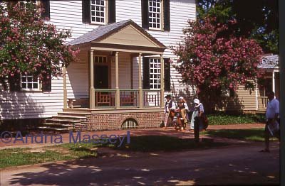 Colonial Williamsburg Virginia USA Costumed people walking past the James Anderson House

Format: 35mm